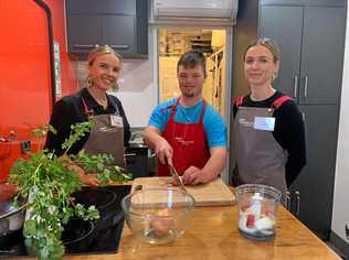 CROSS CHOPPING KING: Tarron George working his magic in the kitchen, with Jamie Oliver's Ministry of Food nutritionists and kitchen managers, Bridget Horsey and Lexi Costello. Picture: Rhylea Millar