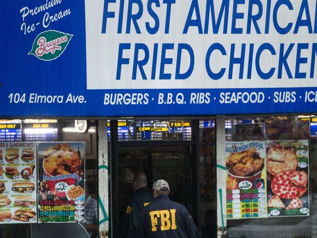 Members of the FBI enter a fried chicken store underneath the residence being investigated in connection to Saturday night's bombing in Manhattan, September 19, 2016 in Elizabeth, New Jersey.