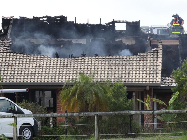 Smoke coming from the charred remains of Mr Brand’s Maudsland home. Picture: Glenn Hampson.