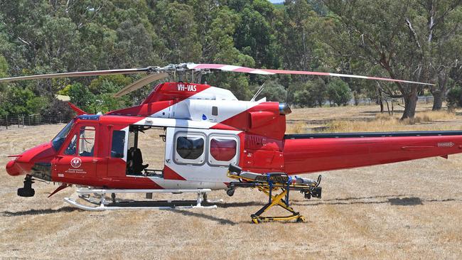 The rescue helicopter in a paddock near where a man was killed in a freak car accident at a business in Woodside. Picture: Tom Huntley