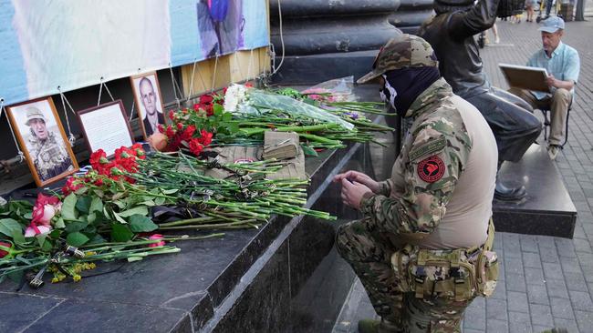 A member of the Wagner group pays tribute to Yevgeny Prigozhin, at the makeshift memorial in front of the circus building in Rostov-on-Don. Picture: AFP.