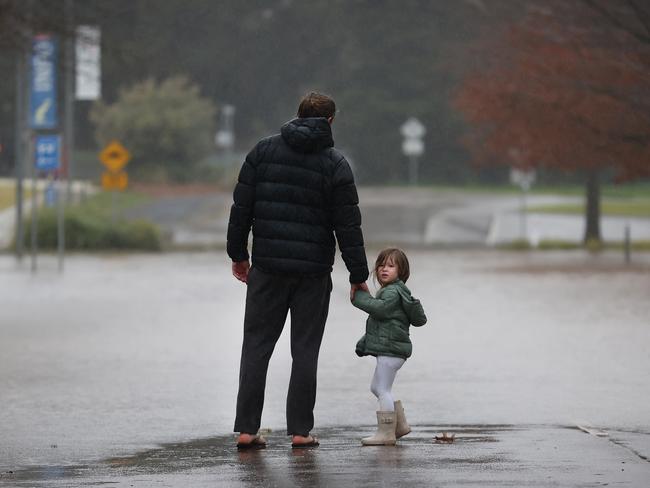 Sale flood water. Derek Harman and daughter Charlotte 3, look at the floodwater over Canal Rd from ÃFlooding CreekÃ.                      Picture: David Caird