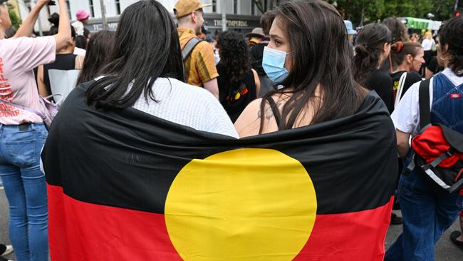 MELBOURNE, AUSTRALIA - JANUARY 26: Protesters participate in the Treaty Before Voice Invasion Day Protest outside Parliament House on January 26, 2023 in Melbourne, Australia.  Australia Day, formerly known as Foundation Day, is the official national day of Australia and is celebrated annually on January 26 to commemorate the arrival of the First Fleet to Sydney in 1788. Many indigenous Australians refer to the day as 'Invasion Day' and there is a growing movement to change the date to one which can be celebrated by all Australians. (Photo by Alexi J. Rosenfeld/Getty Images)