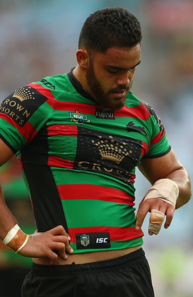 Dylan Walker of the Rabbitohs looks down at his injured hand.