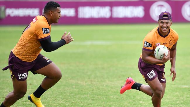 Tesi Niu (right) gets past Tevita Pangai Junior at Broncos training. Picture: AAP Image