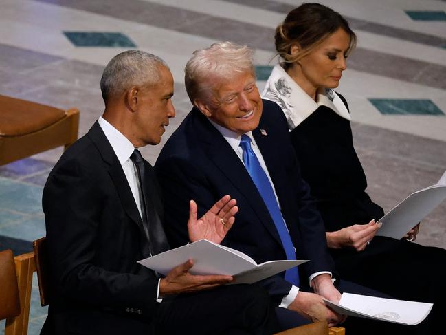 Donald Trump chats and laughs with former US president Barack Obama at Jimmy Carter’s funeral. Picture: Getty Images via AFP