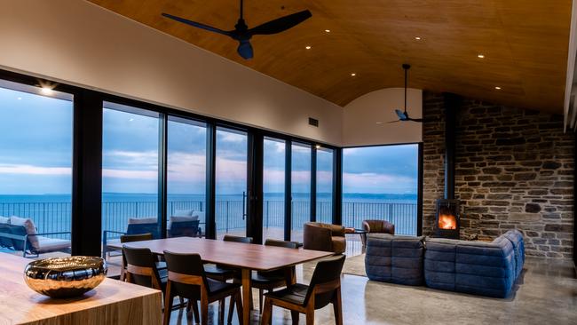 This is what winter coastal living is all about – a roaring fire and water views. Pic: supplied.