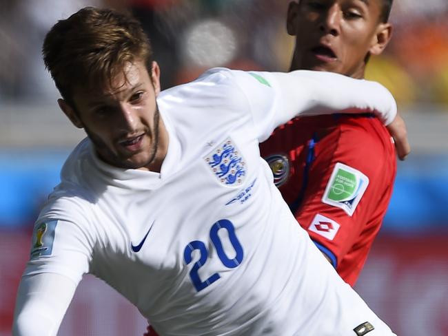 England's midfielder Adam Lallana (L) is tackled by Costa Rica's defender Oscar Duarte during the Group D football match between Costa Rica and England at The Mineirao Stadium in Belo Horizonte on June 24, 2014,during the 2014 FIFA World Cup . AFP PHOTO / FABRICE COFFRINI