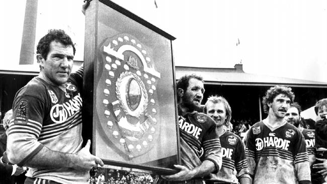 Mick Cronin and Ray Price hold aloft the JJ Giltinan Shield after the 1986 grand final as Peter Sterling, Brett Kenny and Eric Grothe look on. Picture: Peter Kurnik