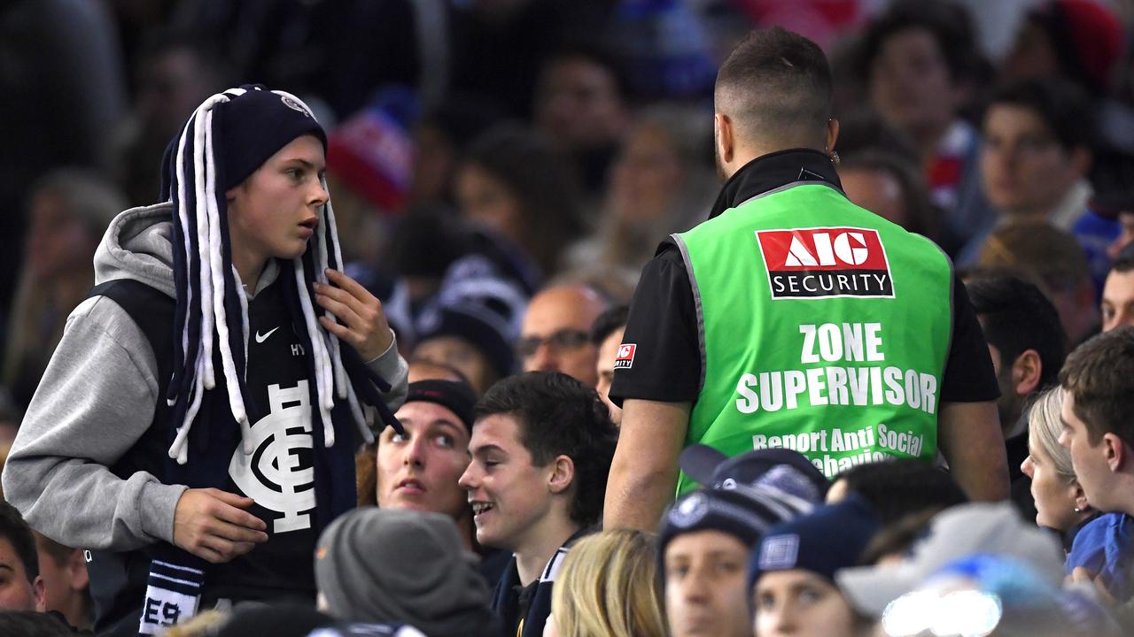Security remove a member from the crowd during Carlton-Western Bulldogs clash.