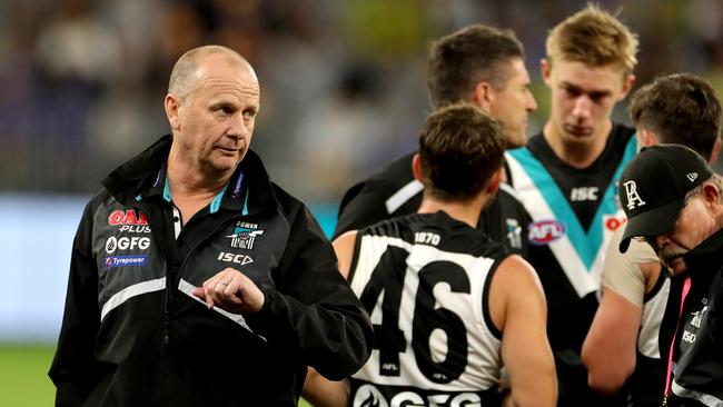 Ken Hinkley (left) coach of the Port Adelaide Power talks to his players during the win over the Eagles at Optus Stadium in Perth. Picture: AAP Image/Richard Wainwright