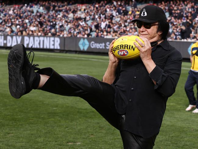 Carlton Blues fan Gene Simmons presents the match-day ball for the clash against the Collingwood Magpies at the MCG. Picture: Michael Klein