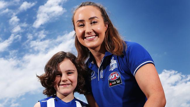 Nina Johnston, 7, of Hobart, with AFLW North Melbourne player Nicole Bresnehan. Picture: NIKKI DAVIS-JONES