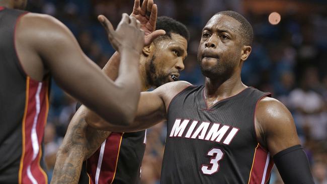Miami Heat's Dwyane Wade gives a high-five to Luol Deng.