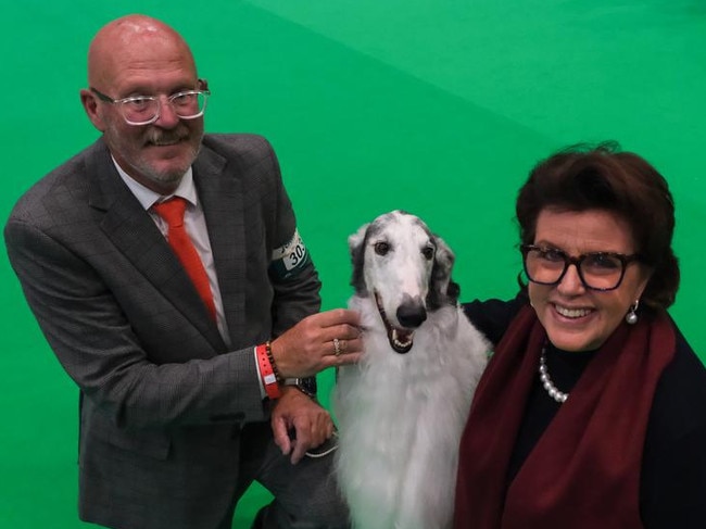 Five year old Kohl, gets a congratulatory hug from handler Gerald Munro and owner Kay Sneath. Picture: Jacquelin Magnay