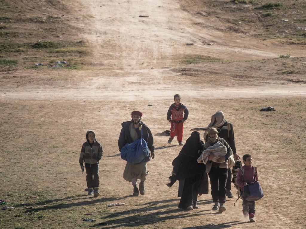 Civilians on the outskirts of Baghouz after walking hours to flee fighting. Picture: Chris McGrath/Getty Images