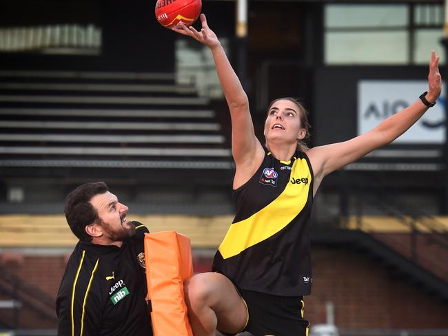 Brendon Gale works with Tigers signing Alice Edmonds on her ruck craft. Picture: Tony Gough