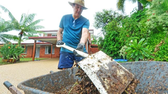 Fergus Molloy cleans up out the front of his Marabou Drive home in Annandale. Picture: Zak Simmonds