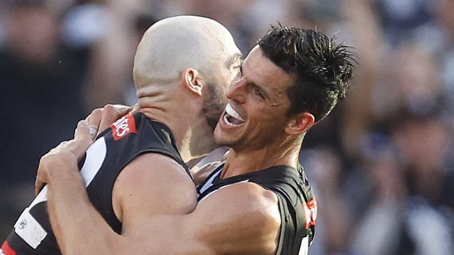 MELBOURNE, AUSTRALIA - SEPTEMBER 30: Steele Sidebottom of the Magpies celebrates with Scott Pendlebury of the Magpies after kicking a goal during the 2023 AFL Grand Final match between Collingwood Magpies and Brisbane Lions at Melbourne Cricket Ground, on September 30, 2023, in Melbourne, Australia. (Photo by Daniel Pockett/AFL Photos/via Getty Images)