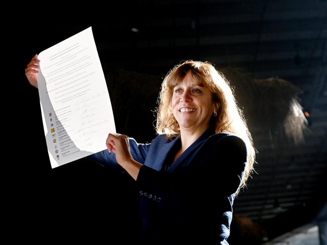 Rachel Perkins holds aloft the signatures of   peak religious institutions, calling on Australian political leaders to take action on a First Nations Voice Referendum, as advocated by the Uluru Statement from the Heart at The Cutaway in Barangaroo, Sydney. Photo Jeremy Piper