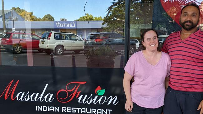 Satnam Singh Rath and his wife Erin Werner in front of their restaurant.