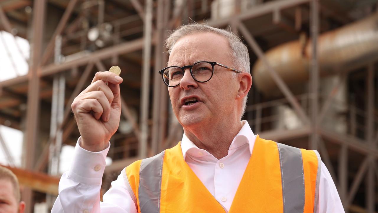 Labor leader Anthony Albanese holds up a dollar coin in Gladstone. Picture: Sam Ruttyn