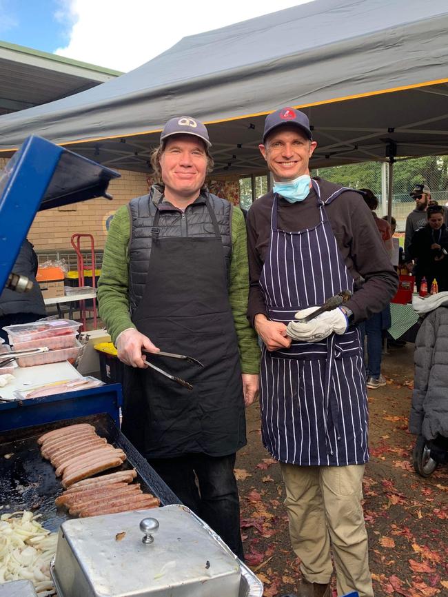 Volunteers Richard Gifford and Luke Unsworth organising a sausage sizzle on election day.