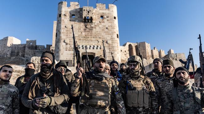 Members of the Syrian armed opposition forces stand in front of the Ancient Castle of Aleppo. Picture: Anas Alkharboutli/picture alliance via Getty Images