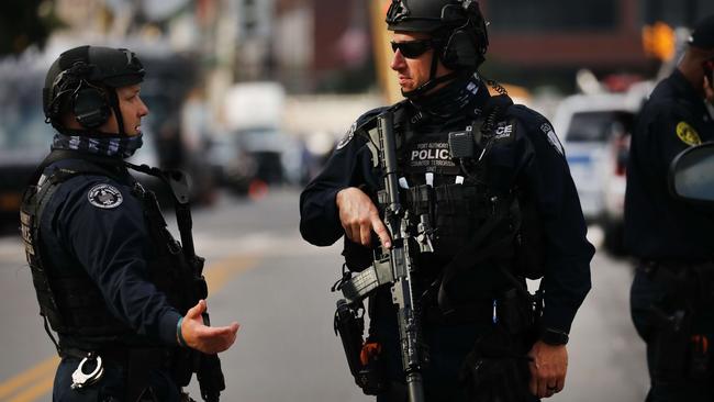 New York City police officers stand guard across from One World Trade Centre in lower Manhattan during commemoration ceremonies for the September 11 terror attacks. Picture: Getty Images/AFP