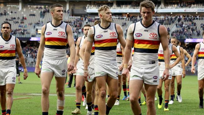 Adelaide players leave the field after their loss to Fremantle. Picture: AAP