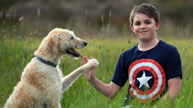 Rikki, 11, with his dog Bubba has written a letter to his bullies. Picture: Andy Brownbill