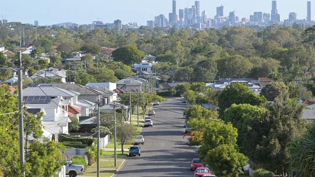 Brisbane - Nov 18 2023:Residential houses street against Brisbane City skyline.Home prices across Australia have hit new highs, with the median value of a home in a capital city shooting to $832,000. housing suburbs generic