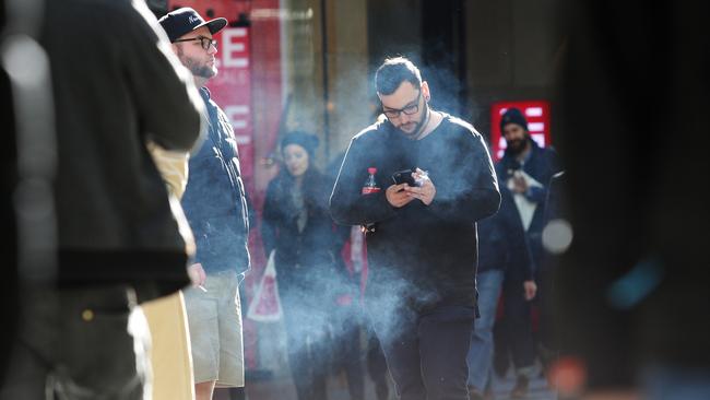 Smokers in Pitt St Mall who will be unable to smoke following the ban later this year.