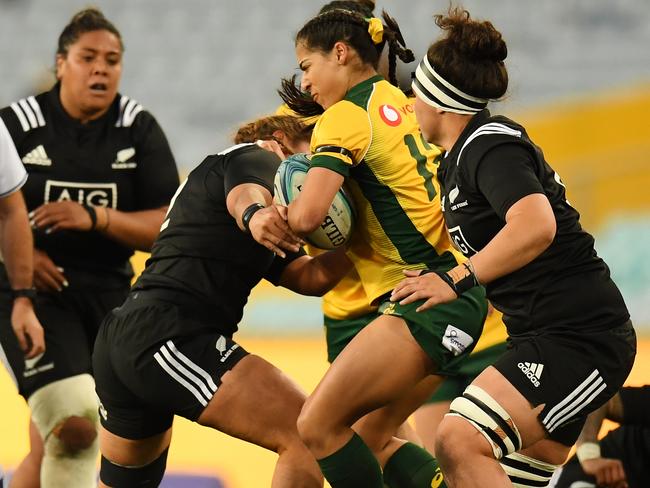 Crystal Maguire of the Wallaroos bursts into the Black Ferns defence during the Women's International Rugby match between Australia and New Zealand in Sydney, on August 18, 2018. (AAP Image/Dean Lewins)