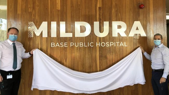 Mildura Base Public Hospital chief executive Terry Welch and capital projects and contract manager Don Palazzo unveil the new Mildura Base Public Hospital signage at the front entrance.