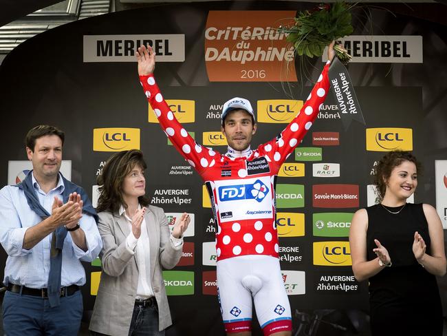 French rider Thibaut Pinot celebrates his polka dot jersey on the podium after Stage 7 of the Dauphine Criterium.