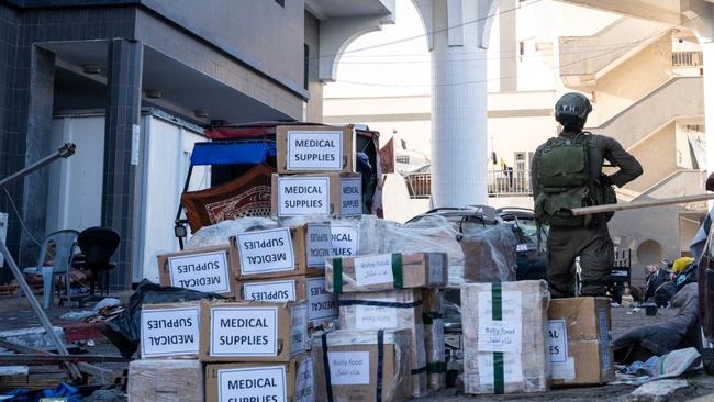 An Israeli soldier stands outside al-Shifa hospital next to boxes of medical supplies the army said it had delivered to the health centre during their operation. Picture: AFP.