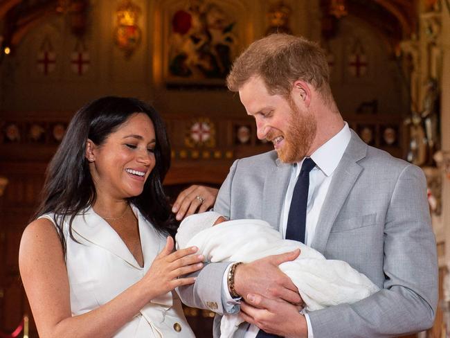 (FILES) Britain's Prince Harry, Duke of Sussex (R), and his wife Meghan, Duchess of Sussex, pose for a photo with their newborn baby son, Archie Harrison Mountbatten-Windsor, in St George's Hall at Windsor Castle in Windsor, west of London on May 8, 2019. Prince Harry would 