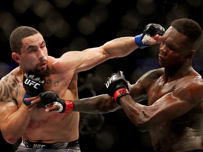 Robert Whittaker and Israel Adesanya during their middleweight championship fight at UFC 271 in February.