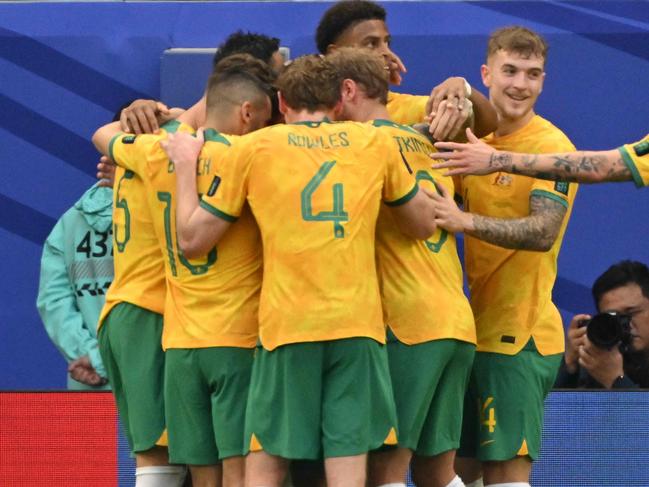 Australia's players celebrate their first goal during the Qatar 2023 AFC Asian Cup Group B football match between Australia and Uzbekistan at the Al-Janoub Stadium in Al-Wakrah, south of Doha on January 23, 2024. (Photo by Hector RETAMAL / AFP)