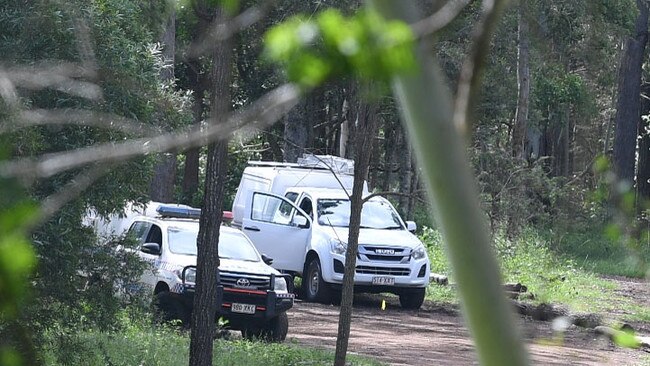 Police on the long driveway on the property at Amamoor.