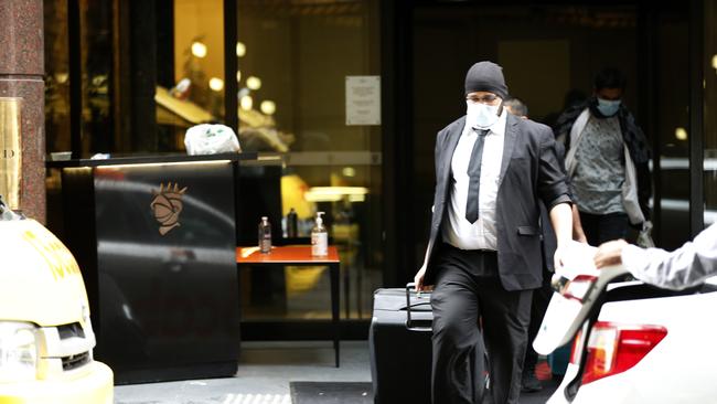 A guest’s luggage is taken to a waiting taxi from one of Melbourne’s coronavirus quarantine hotels, the Stamford. A probe has been ordered after revelations security guards contracted to guard the hotels contributed to outbreaks across the city. Picture: Getty