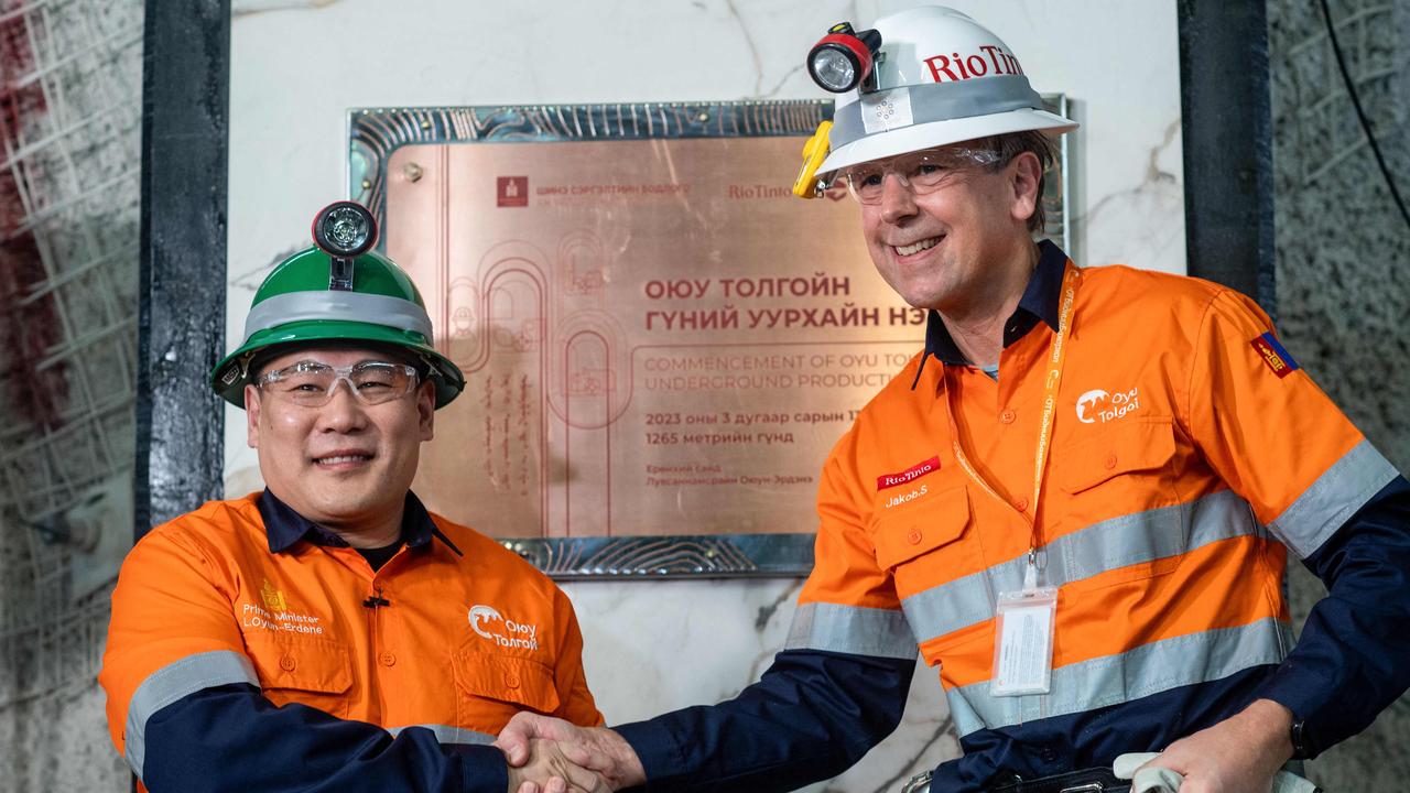 Mongolia's Prime Minister Luvsannamsrai Oyun-Erdene (L) shakes hands with CEO of Rio Tinto Jakob Stausholm at the Oyu Tolgoi copper mine in southern Mongolia. Picture: AFP