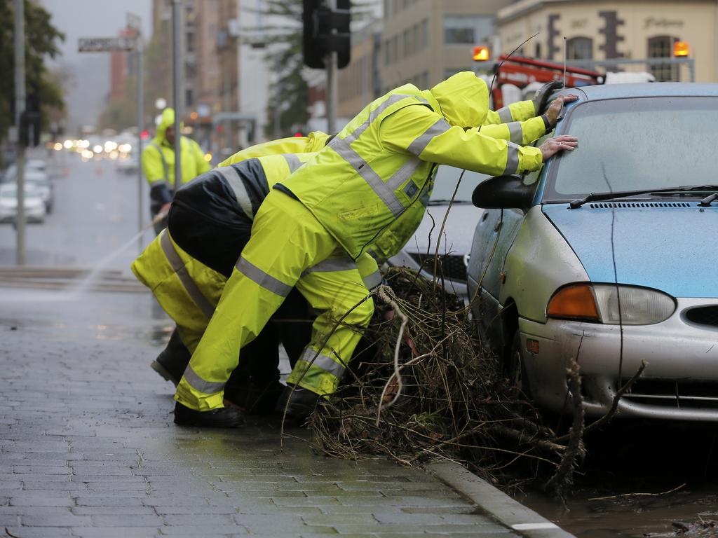 Crews clear debris left by overnight floods on Macquarie St, Hobart. Picture: MATHEW FARRELL