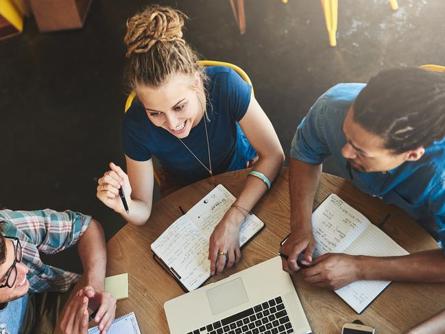 High angle shot of a group of students studying in a coffee shop