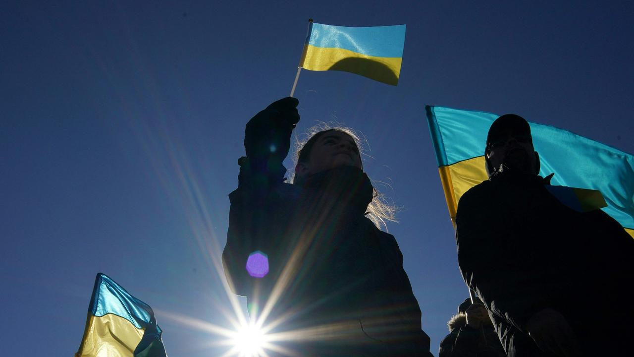 People wave Ukrainian flags during a Day of Solidarity with Ukraine at the Lincoln Memorial in Washington, DC. Picture: Stefani Reynolds/AFP