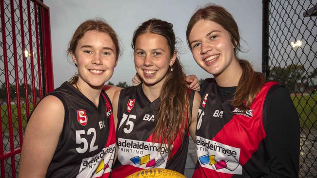 West Adelaide under-16 footballers Rosie Tennant, Ruby Burgess and Madison Kravinskis at Richmond ahead of Friday night’s live streamed matches. Picture: Emma Brasier