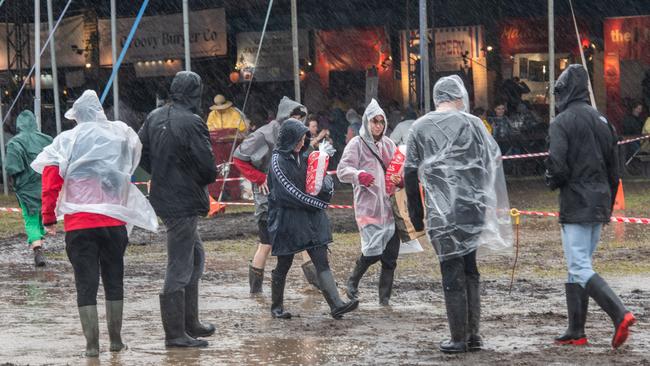 Festivalgoers are seen in the rain and the mud at Splendour in the Grass 2022 in Byron Bay. Picture: Marc Grimwade / WireImage