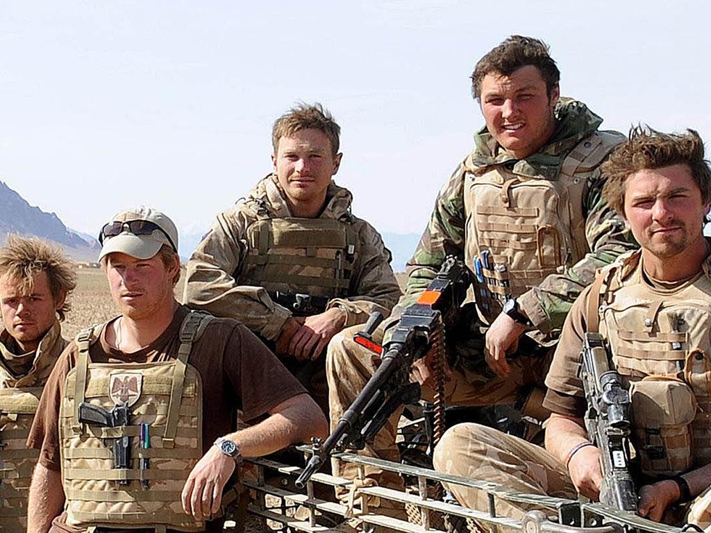 Prince Harry poses with soldiers in the Afghani desert on February 19, 2008. Picture: John Stillwell / Anwar Hussein Collection/WireImage