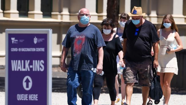 MELBOURNE, AUSTRALIA - NewsWire Photos 23 JANUARY 2022 : People line up for their booster vaccination at the Royal Exhibition Building as the omicron covid-19 variant spreads throughout Australia. Picture : NCA NewsWire / Ian Currie